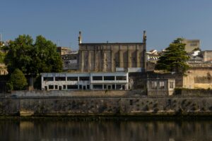 A historic architectural structure along the Douro River in Porto, Portugal, captured in daylight.